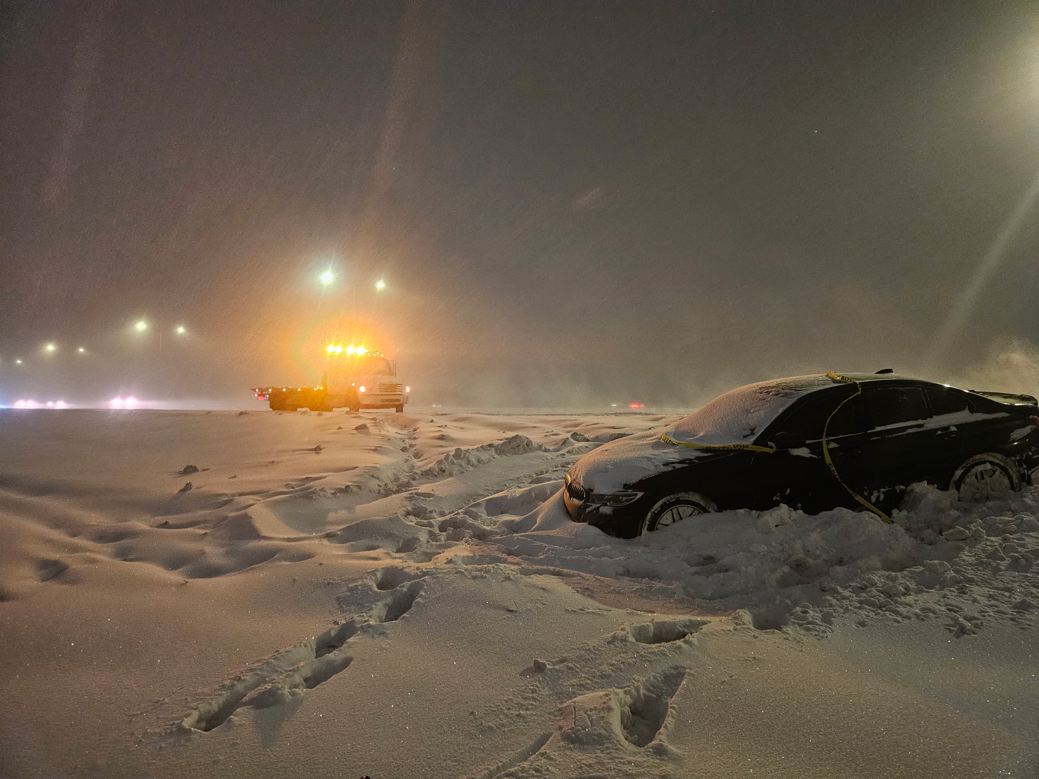snowy ditch rescue with a flatbed tow truck